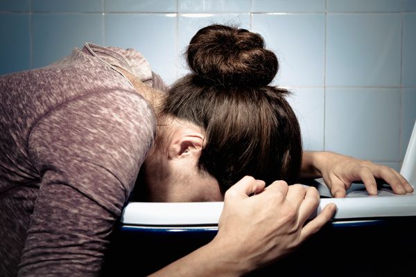 Woman's face over toilet