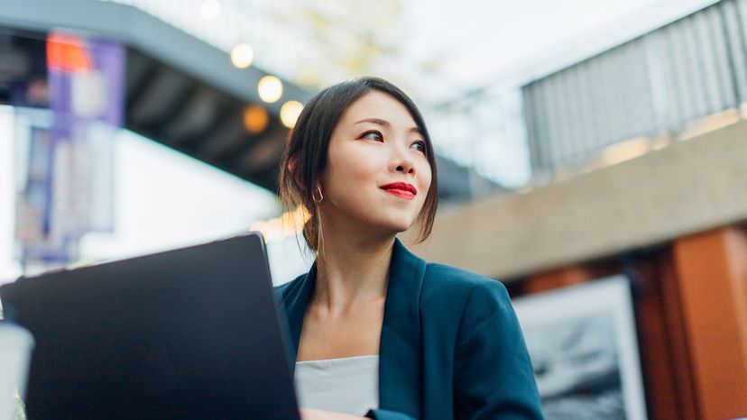 young woman using laptop outside