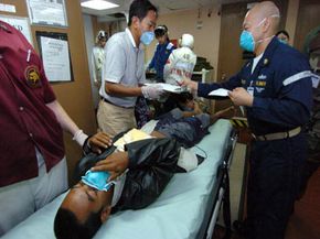 Victims of the 2004 tsunami in Banda Aceh, Indonesia are treated by Project HOPE workers at sea in the Indian Ocean.