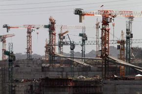 Idle cranes are seen at the construction site of the Panama Canal Expansion project on the outskirts of Colon City, Feb. 12, 2014. The project is already a $1 billion over budget.