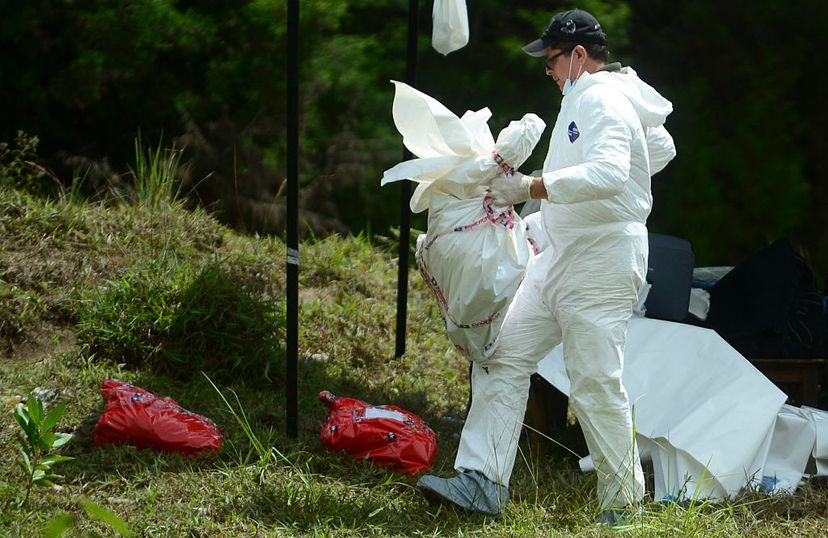 Colombian police inspect corpses found in a mass grave at a farm in Guarne municipality in a case involving another serial killer, in 2016. Luis Garavito reportedly killed 300 people &quot;for pleasure&quot; in the 1990s. RAUL ARBOLEDA/AFP/Getty Images)