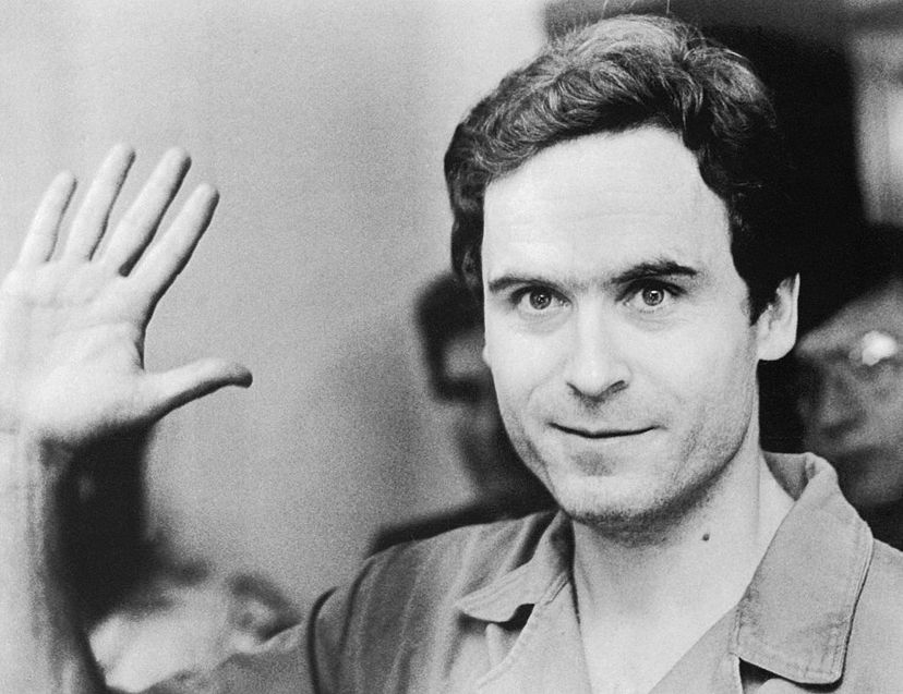 Ted Bundy waves to TV cameras as his indictment for the murders of Florida State University students Lisa Levy and Margaret Bowman is read at the Leon County Jail in Florida. Hulton-Deutsch Collection/Universal History Archive/Getty Images