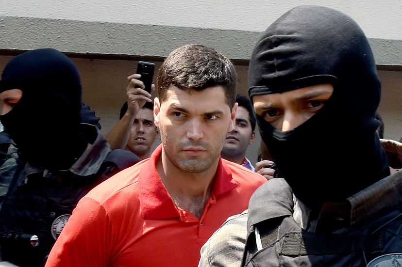 Tiago Gomes da Rocha (C), suspected of killing 39 people, is escorted by police officers at the Department of Security, a day after his arrest in Goiania in the state of Goias, Brazil, on Oct. 16, 2014. EVARISTO SA/AFP/Getty Images