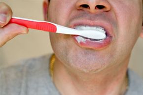man brushing teeth