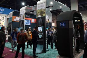 Attendees visit the FitBit booth at the 2014 International CES at the Las Vegas Convention Center. FitBit makes devices that allow you to monitor your sleep patterns, calorie intake and activity level. See more everyday tech pictures.