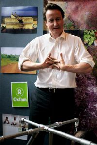 David Cameron cracks his knuckles after assembling a water delivery system with frontline Oxfam workers. See more bodily feat pictures.