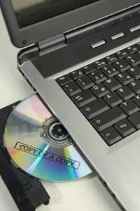 Copied CD in the disc drive of a laptop computer