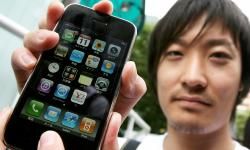 Tetsuya繁华与他的新苹果iPhone在日本推出的第一天。”border=