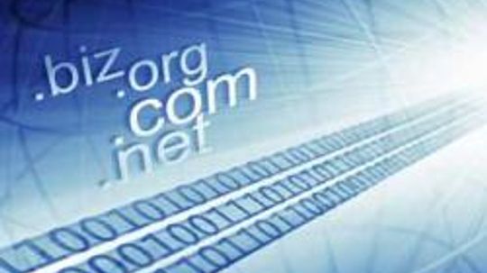 What are the standard top-level domain names and who controls them?