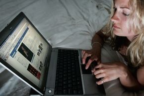 A girl browses Facebook on a computer.