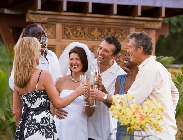 Friends toast with newlyweds.