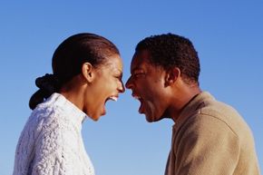 A couple arguing at each other.