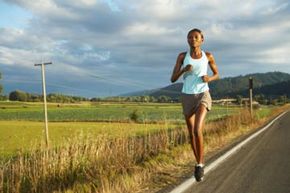 Athlete running outdoors, jogging.