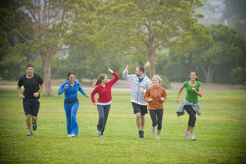 Group of people running outdoors in sport.