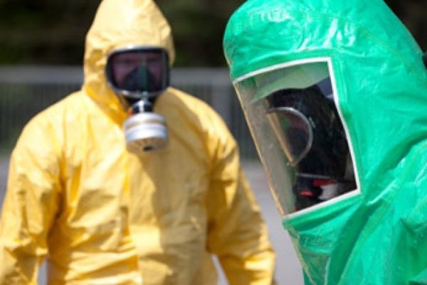 Workers cleaning up radiation in protective gear.