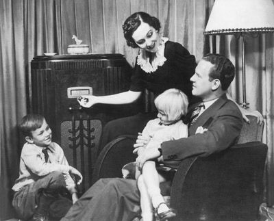 A family listens to the radio.