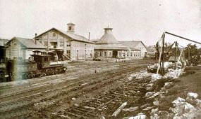 The B&amp;O's division locomotive shop complex at Martinsburg, West Virginia, represents a typical midsized railroad facility of the 1870s. The covered roundhouse was a garage for engines; the rectangular buildings housed workshops and machinery.