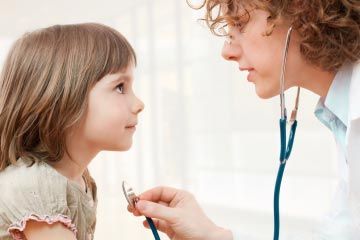 child being examined by doctor