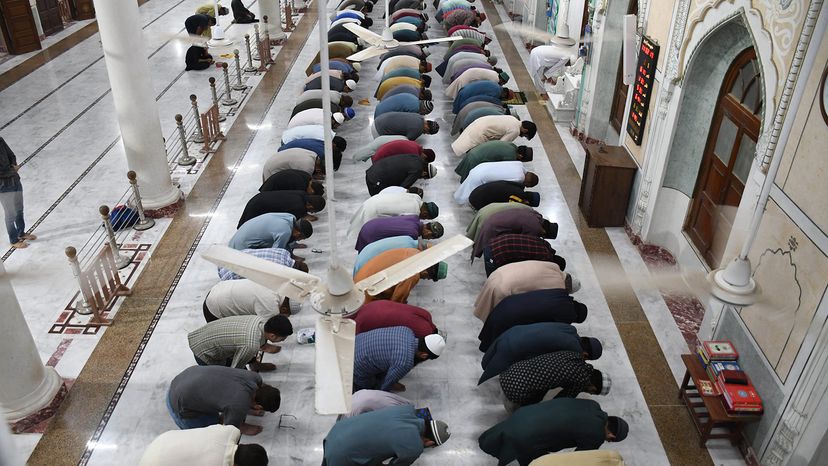 Muslim men perform a tarawih prayer