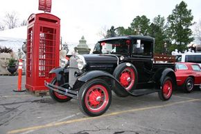 Two examples of some of the vintage pieces sold by the Red Baron: a cast iron phone booth from London and a 1930s Ford Pickup.