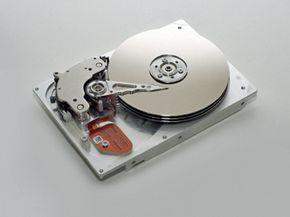 In this picture, it's easy to see this hard drive's platters, which look a bit like CDs stacked one on top of another, and an actuator arm.