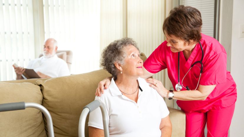 nurse taking care of elderly woman