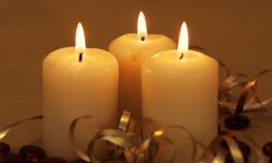 Three candles with gold ribbon and red beads , vertical