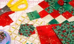 Quilting background for christmas with red, green and gold fabrics.