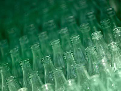 Empty glass bottles being readied for recycling.