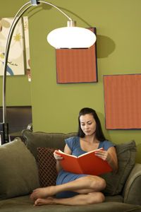 woman reading with lamp
