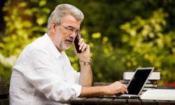 Man outside on computer