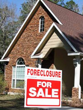 house with foreclosure sign