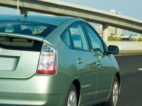 A hybrid car heads down a California freeway.