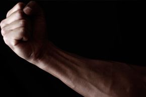 Man's arm on black background