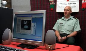 Sgt. Maj. Ronald Simons talks to his son through the Red Cross' Project Video Connect.
