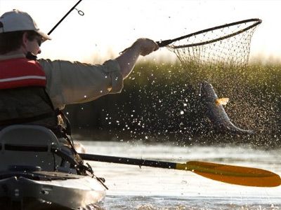 Fisherman enjoying outdoor fishing leisure.