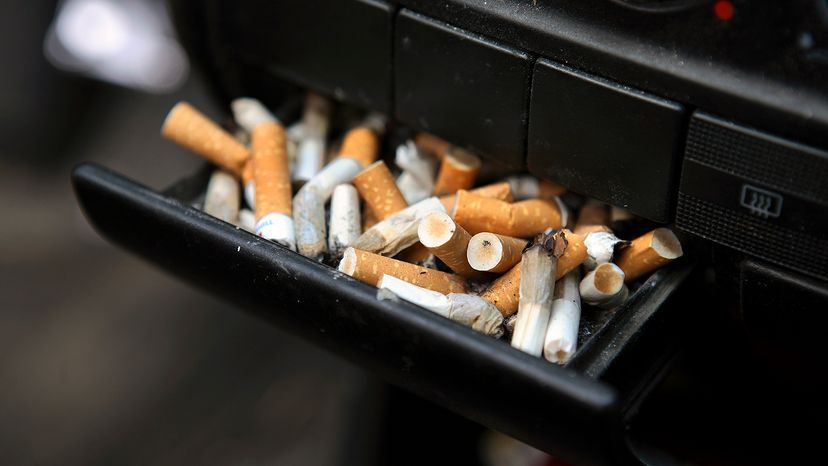 car ashtray full of cigarettes