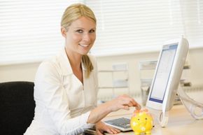 Woman puts money in piggybank