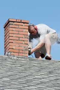 Worker repairing chimney.