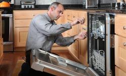 man repairing dishwasher