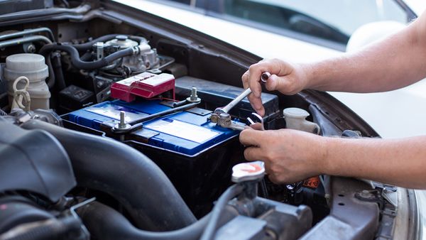 man installing car battery