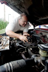 Henry Beghtol, a mechanic for over 40 years, works on his truck's engine in Burlington, Iowa.