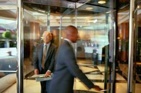 businessmen using revolving door