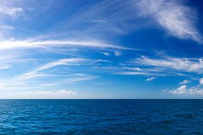 Blue sky, fluffy clouds, peaceful nature.