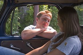 boy looking at girl in car