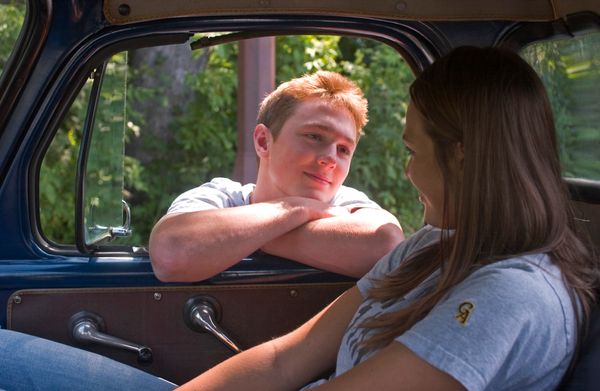 boy looking at girl in car