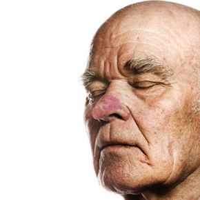 Elderly man's face over white background