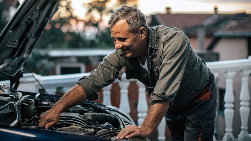 man fixing his car