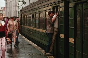 Two men force their way through the closing doors of a commuter train at Leningrad Station in Moscow in 1987.
