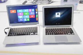 An ultra-thin Samsung Notebook Series 9 laptop computer running Microsoft Windows 8 (left) sits next to an Apple Macbook Air brought by a visitor during a press day at the IFA 2012 consumer electronics trade fair .